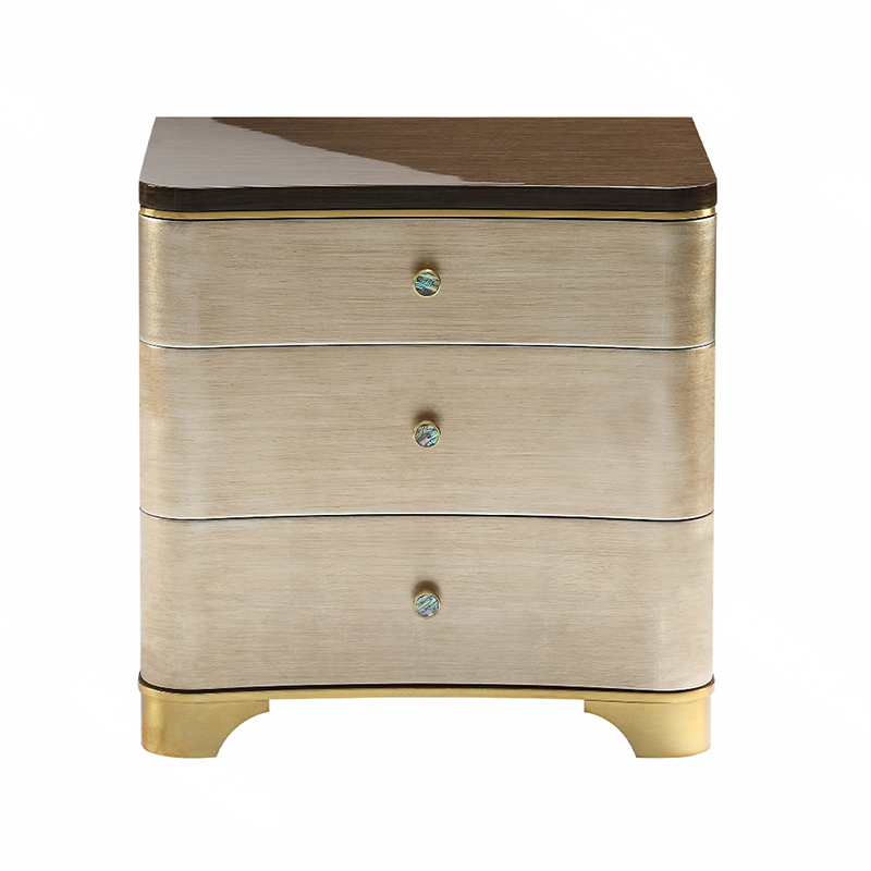 How does the bright gold brushed surface treatment enhance the overall texture of the bedside table?